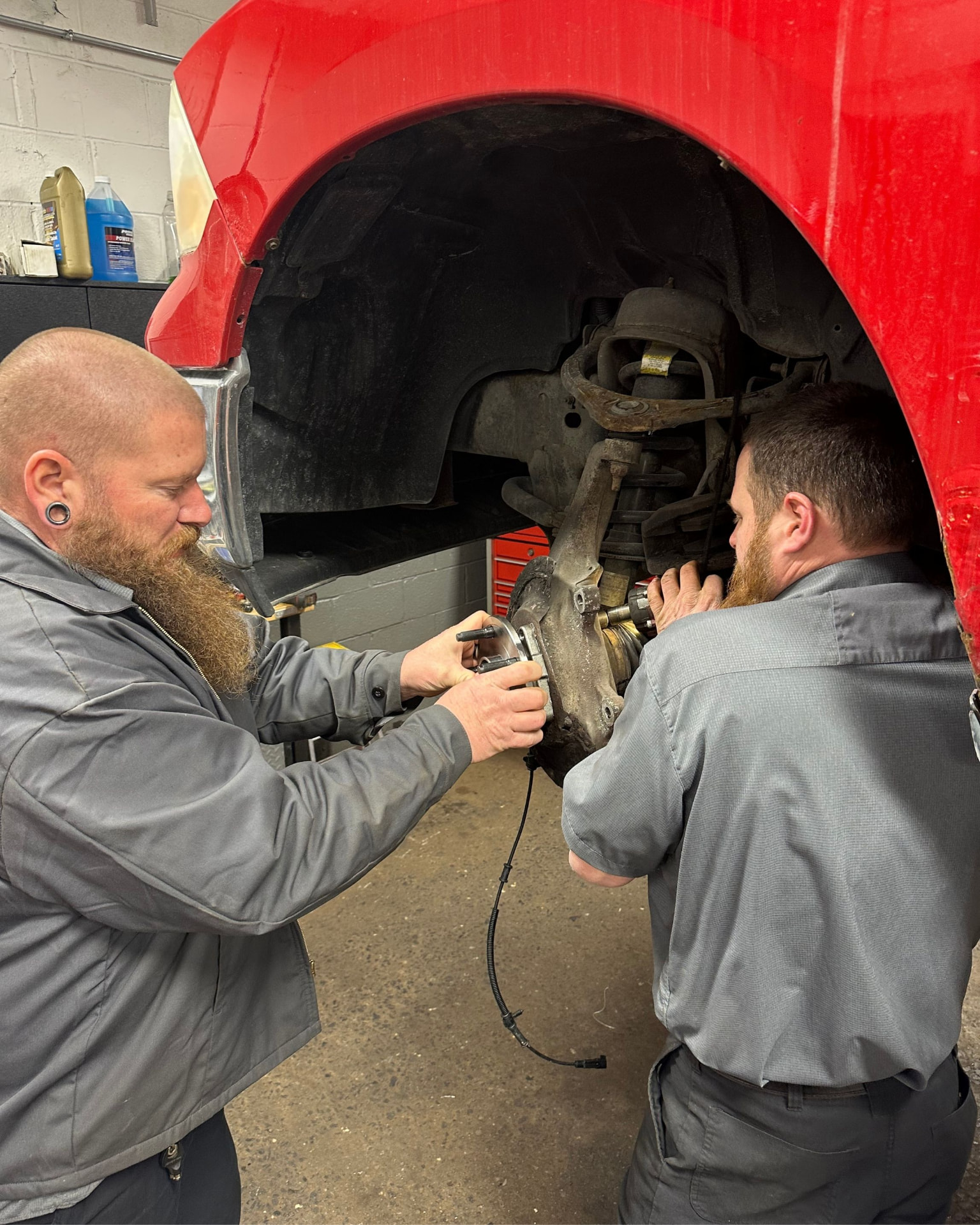 Technician running digital diagnostics on a vehicle